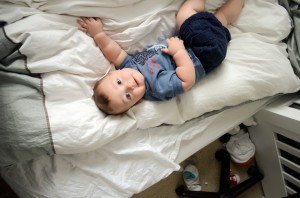 Miles - 9 Month baby photos - Laying on the bed and looking up at me