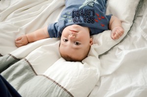 Miles - 9 Month baby photos - Looking back at me from the bed