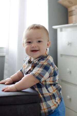 Miles - 9 Months Baby Photo - Showing off his standing skills and smiling like the sweet boy he is