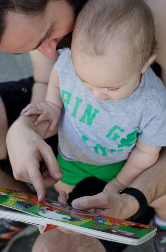 Finn reading "Goodnight Moon" with Daddy outside when he was 12 months old