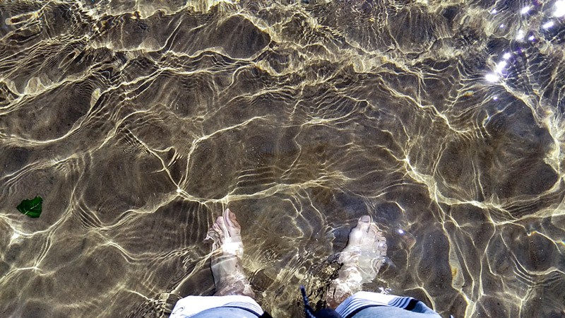 Steven's feet in Lake Tahoe's clear water
