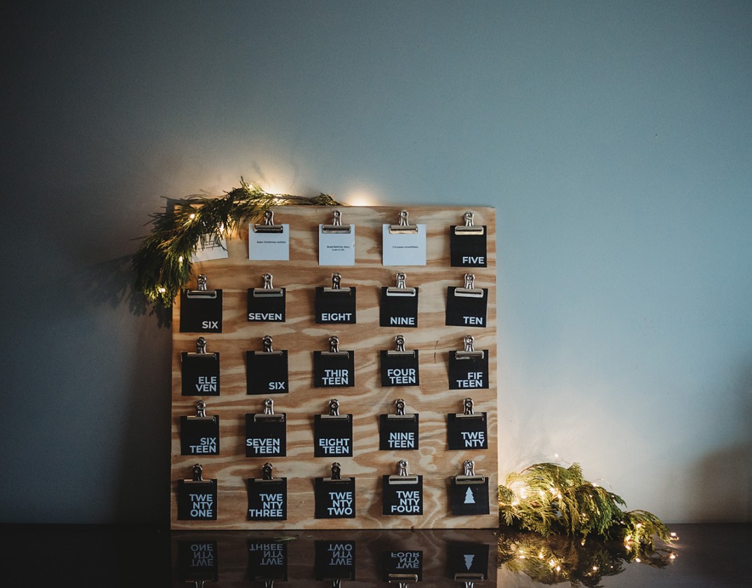 modern advent calendar with black cards with letters written in a heavy font